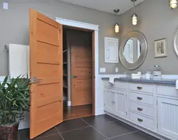 Doors to the bathroom and toilet in the interior photo