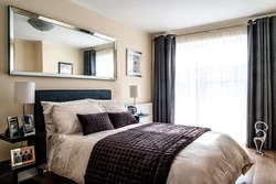 Photo of a bedroom with dark furniture in a modern style