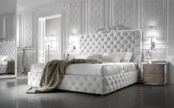 Photo of a bedroom with a soft headboard