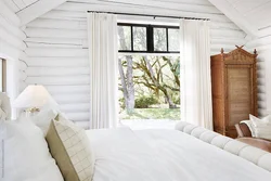 Bedroom interior of a wooden house made of logs