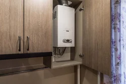 Kitchen with corner stove and gas water heater photo