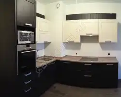 Photo of a kitchen with a ventilation duct in the corner photo