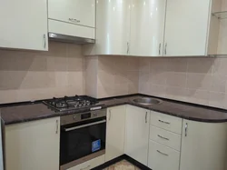 Photo of a kitchen with a ventilation duct in the corner photo