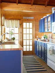 Kitchens on one wall in a wooden house photo
