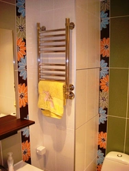 Heated towel rail in the bathroom interior