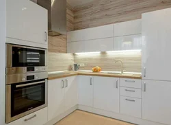 Wallpaper in the interior of a white kitchen with wood