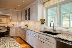 Kitchen with sink by the window in the house interior