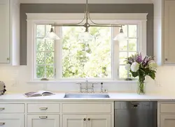 Kitchen with sink by the window in the house interior