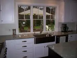 Kitchen with sink by the window in the house interior