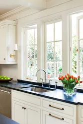 Kitchen with sink by the window in the house interior
