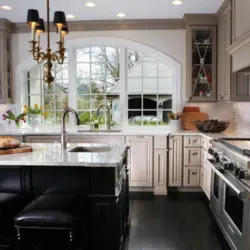 Kitchen with sink by the window in the house interior