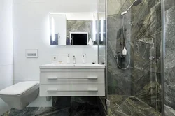Small bathroom in marble tiles photo