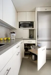 Corner kitchen design with refrigerator in the corner