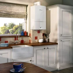 Photo Of A Kitchen With A Gas Boiler On The Wall And Pipes