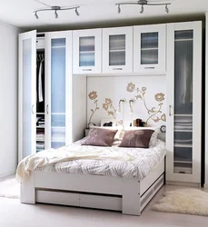 Wardrobes above the bed in the bedroom photo