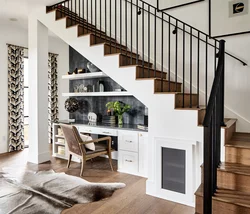 Kitchen in a house with stairs to the second floor design photo