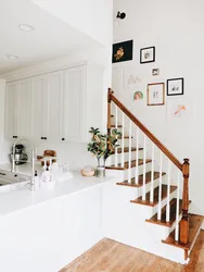 Kitchen In A House With Stairs To The Second Floor Design Photo