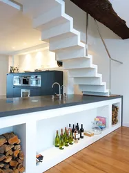 Kitchen in a house with stairs to the second floor design photo