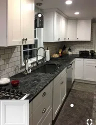 Photo of a kitchen with a black countertop and apron photo