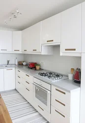 Interior of a white glossy corner kitchen