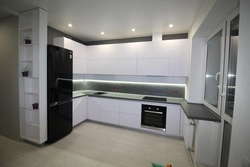 Interior Of A White Glossy Corner Kitchen