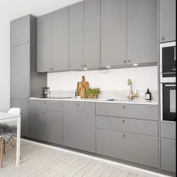 Gray kitchen in the interior combination with wallpaper