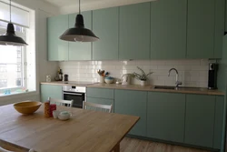 Green kitchen with wooden countertops in the interior