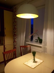 Chandelier above the dining table in the kitchen photo