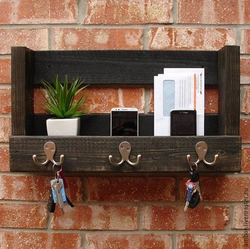 Key holders in the hallway photo wall made of wood