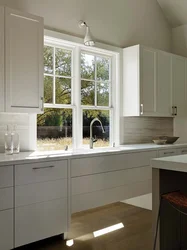 Kitchen with a large window in the middle design