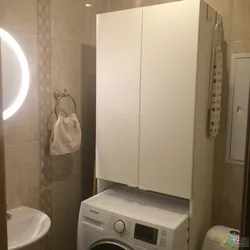 Bathroom cabinet above the washing machine photo