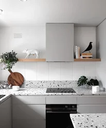 White kitchen with gray countertop and apron in the interior photo