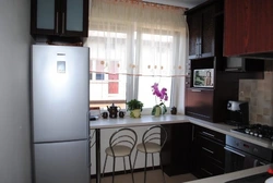 Kitchen design with refrigerator by the window