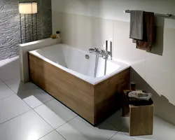 Photo of a bathroom with a bathtub in the middle