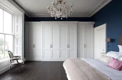 White wardrobe in bedroom interior