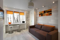 Photo of the interior of a one-room apartment with a balcony