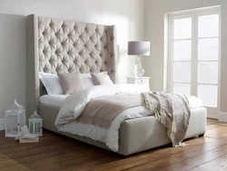 Bedroom design with a bed with a soft headboard