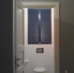 Louvered doors in the bathroom interior