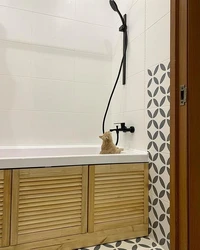 Louvered doors in the bathroom interior