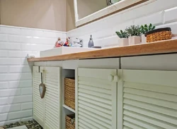 Louvered doors in the bathroom interior