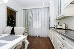 White curtains in the kitchen in the interior photo