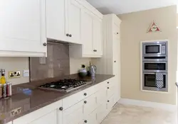 Beige kitchen with light countertop photo