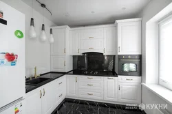 Black Appliances In The Interior Of A Light Kitchen