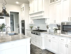 Black appliances in the interior of a light kitchen