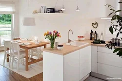 White Kitchen And Wooden Table Photo