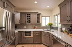 Kitchen design in a modern corner style with a window in the house