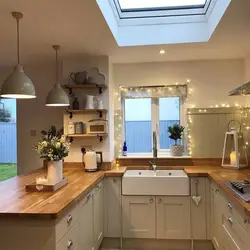 Kitchen design in a modern corner style with a window in the house