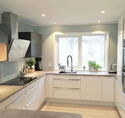 Photo of a kitchen with a window in light colors