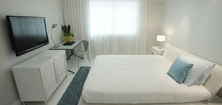 Bedroom interior with bed and tv