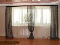 Curtains for two windows with a wall photo in a modern living room